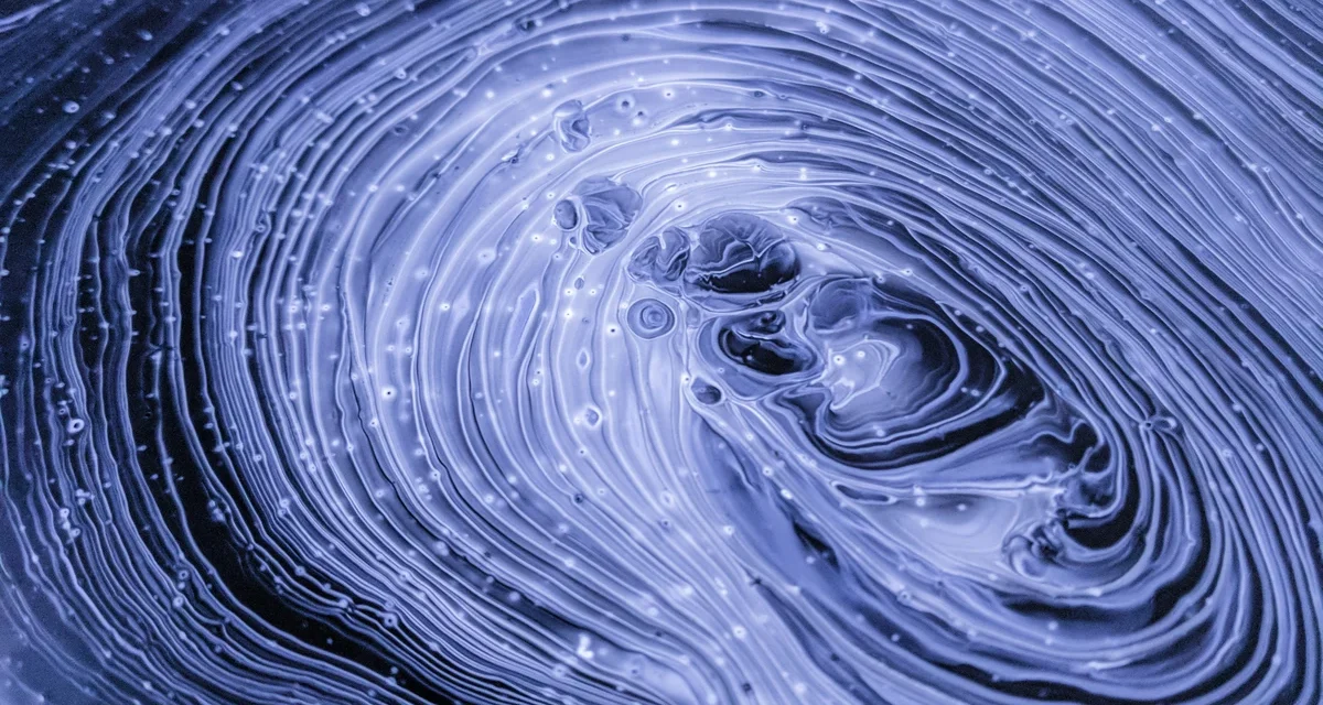 Painting on a blue background, featuring swirls of black, grey, purple and white